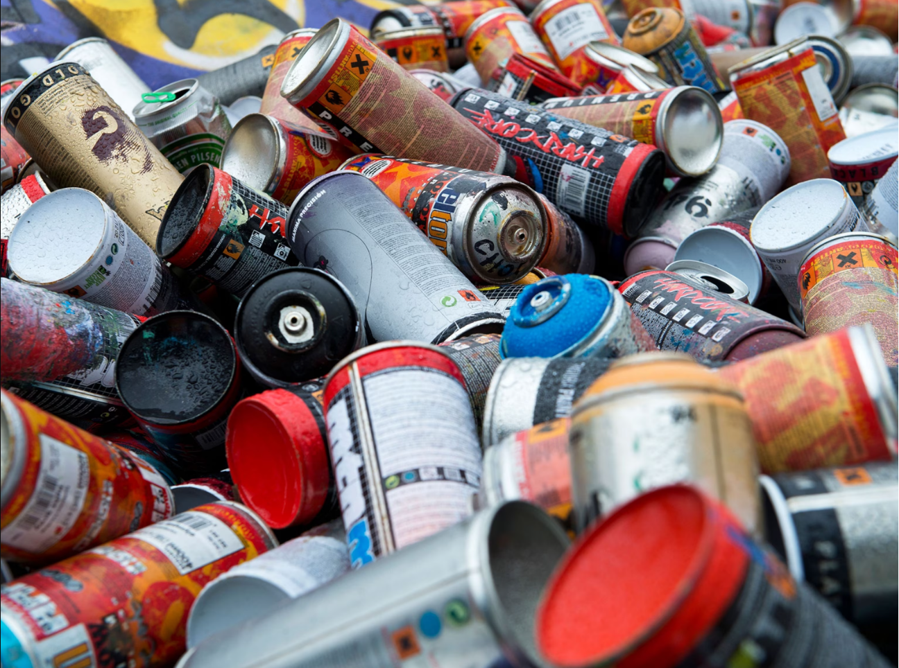 A pile of colourful areosol cans