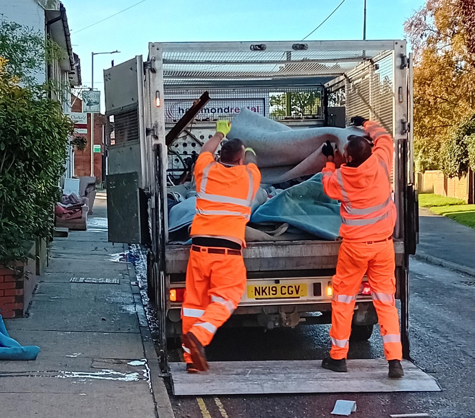 Council operatives loading carpet into lorry