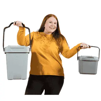 Woman in yellow top holding two food waste caddies