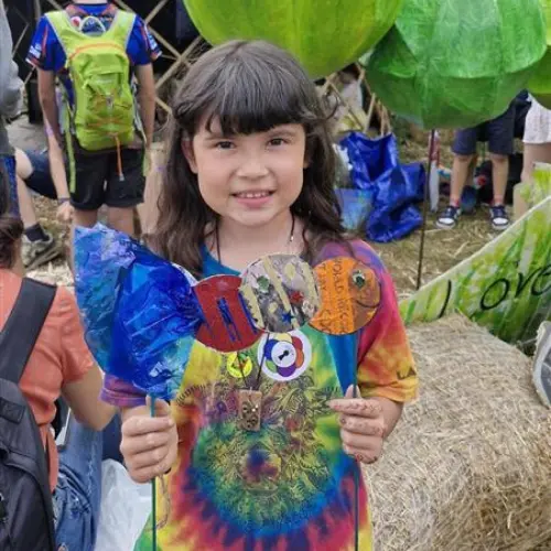 Girl with rainbow cardboard caterpillar