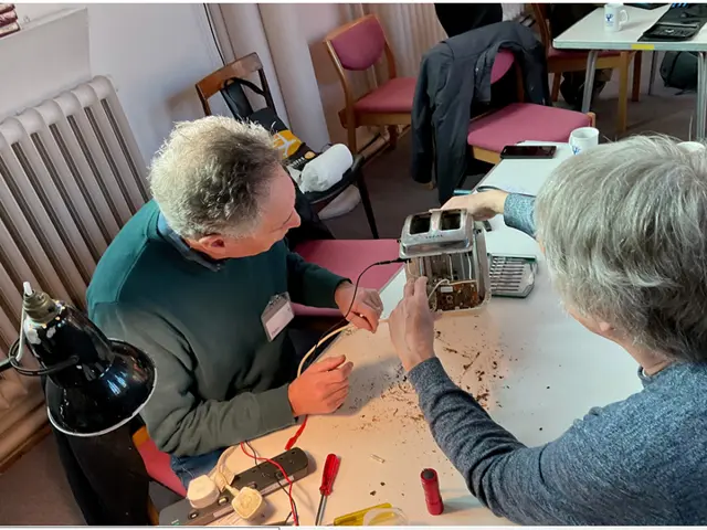 Person fixing an electrical item at a repair cafe.