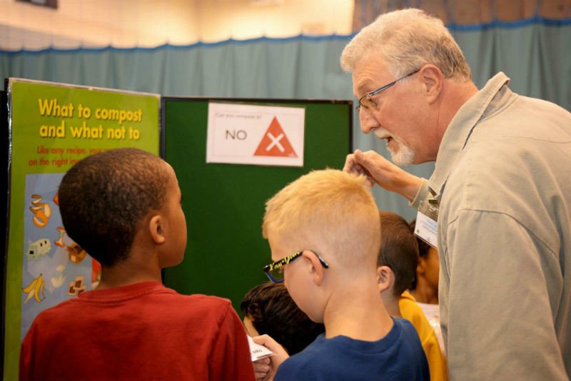 Man talking to kids in school about recycling