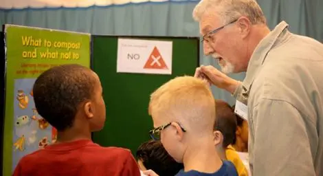 Man talking to kids in school about recycling