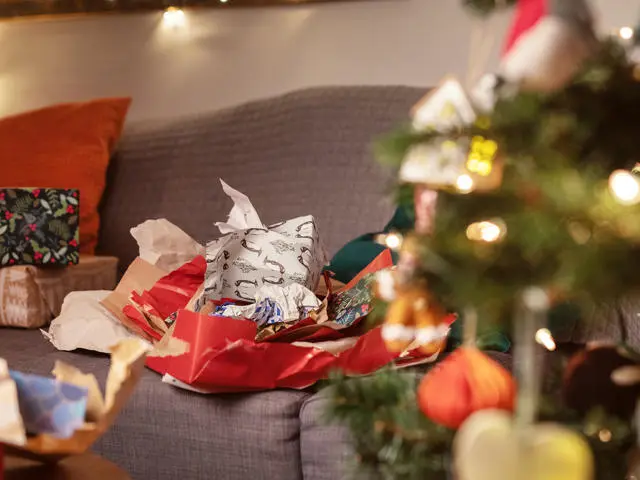 Used wrapping paper next to a Christmas tree