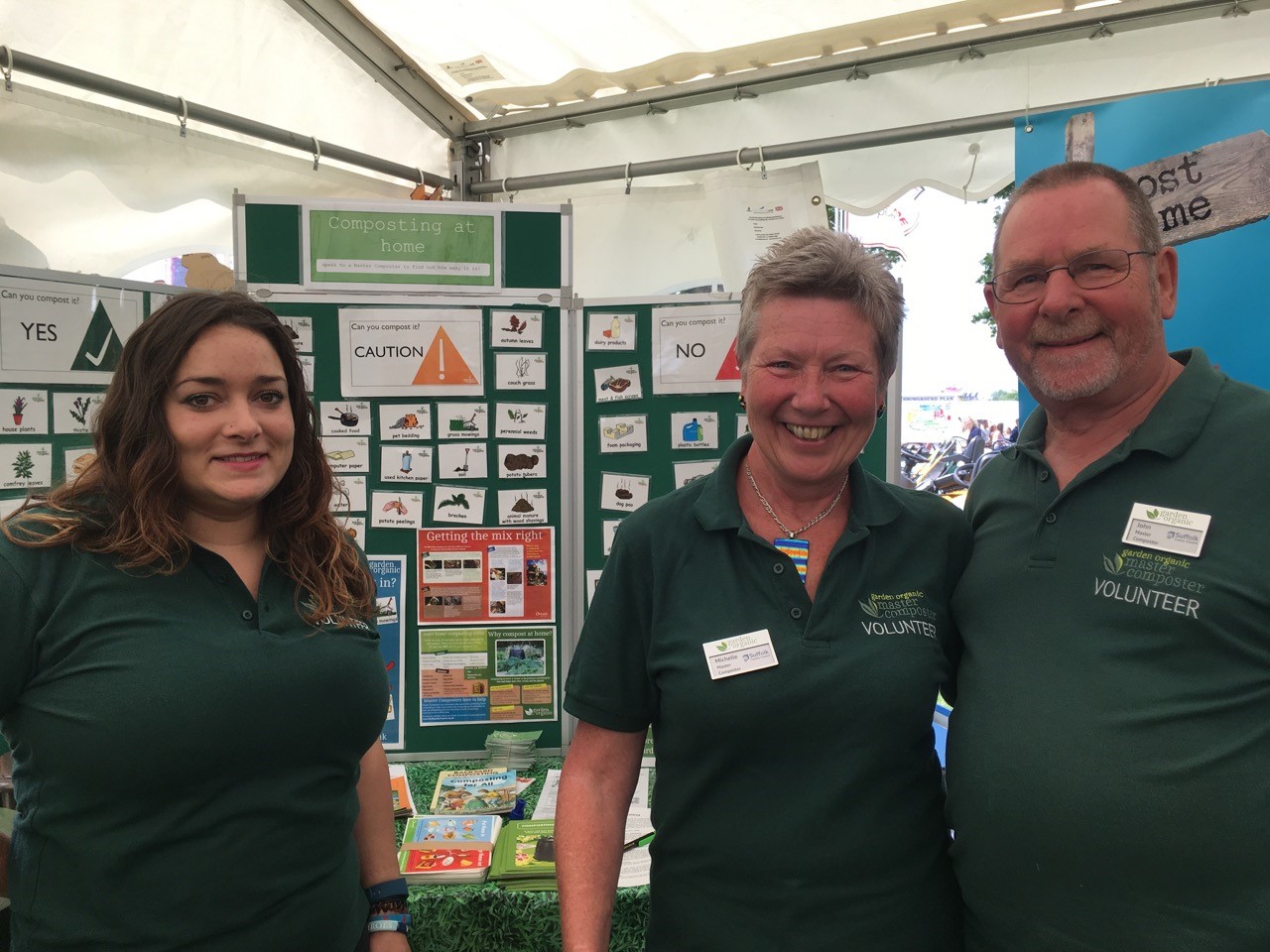 Master Composter volunteers in front of compost display