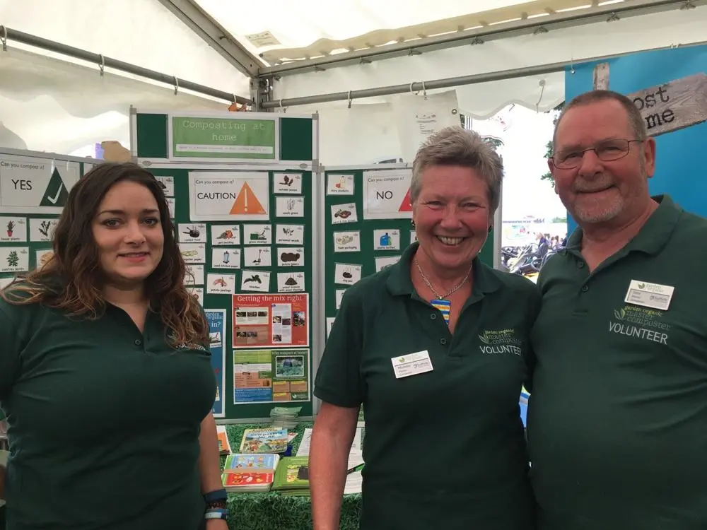 Master Composter volunteers in front of compost display