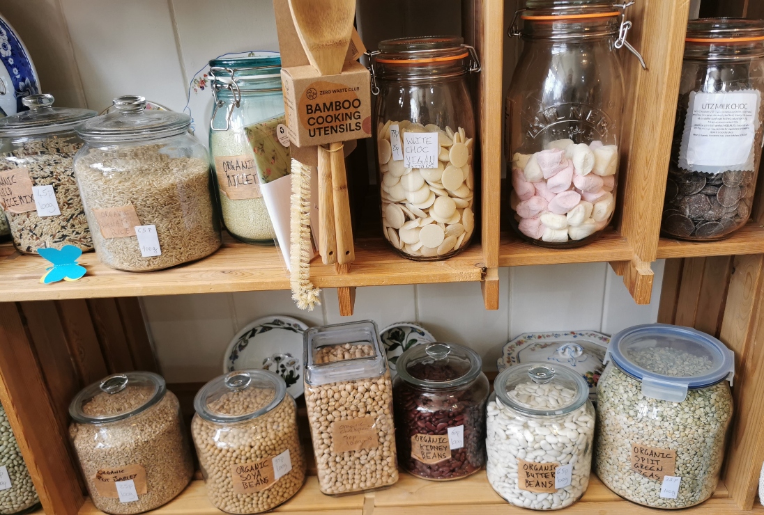Selection of dried goods in jars and containers in a refill shop. 