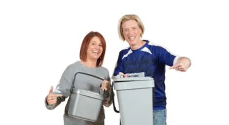 Two women holding food waste caddies