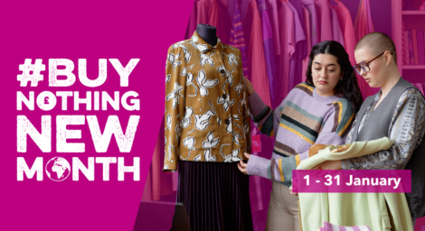 Two people looking at a garment on a mannequin.